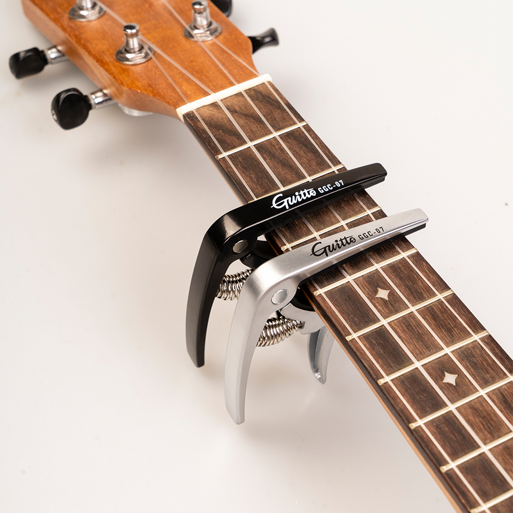 GUITTO GGC-07 Ukulele Capo Qui - مراجعة Musical Instrument In English وسعره